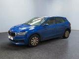 a blue car parked in a room with a white wall