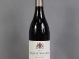 a bottle of red wine sitting on top of a table