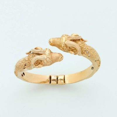 a gold ring that has two birds on it