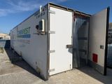 a white container with a door open on the side of the road