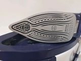 a close up of a blue and white iron on a white table