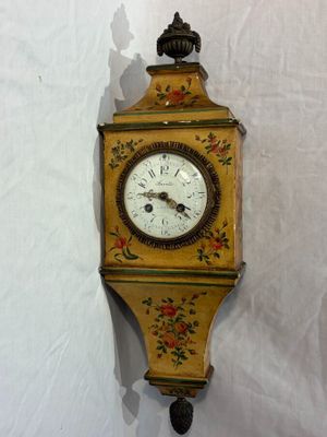 a clock hanging on the wall with a bird on it