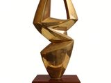 sculpture of a golden sculpture on a wooden base on a white background
