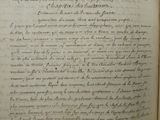 an old book with writing on it sitting on top of a table