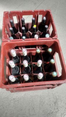 many bottles of beer in a red crate on the floor