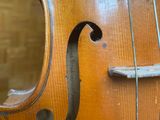 a close up of a violin that is sitting on a table