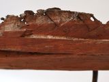 a wooden boat that is sitting on a stand