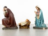 three figurines of jesus and mary in a manger with a baby jesus in the manger