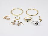 six pairs of gold and silver rings and a pair of earrings