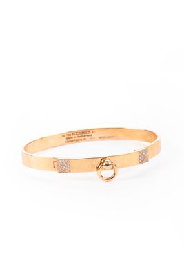 a gold bang bracelet with a diamond clasp