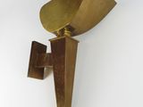 brass wall sconce with a triangular shape on a white background