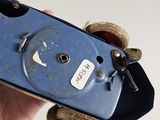 a person holding a blue skateboard with a key on it