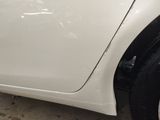 a close up of a white car with a broken door handle
