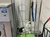 a green mat on the floor next to a metal cart