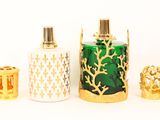 three bottles of perfume sitting next to each other on a white surface