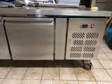 a stainless steel counter with a microwave on top of it
