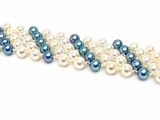 a close up of a row of pearls on a white surface