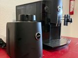 two coffee machines sitting on a red table