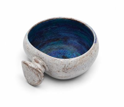 a close up of a small bowl on a white surface