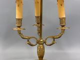 brass plated table lamp with a green shade and two candles