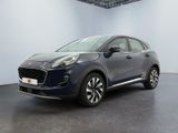 a blue car parked in a white room with a black floor