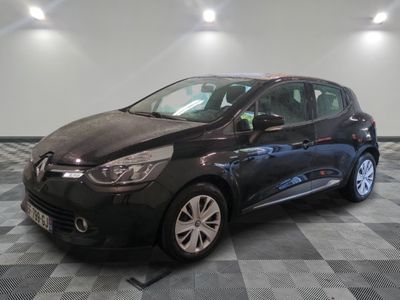 the black car is parked on a checkered floor in the garage