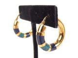 a close up of a pair of hoop earrings on a stand