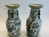 two vases that are sitting on a table