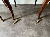 two legs that are standing on the floor next to a table