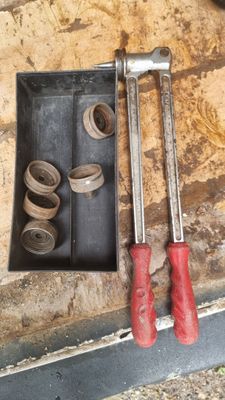 two wrenches and a pair of pliers on the floor