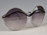 pair of sunglasses on a white surface with a gray background