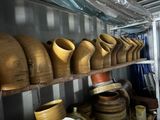 many wooden vases sitting on a shelf in a room