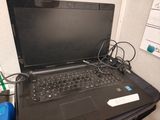 a laptop that is sitting on a desk with a charger