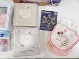 a table with various baby items on it including a bib, bib, bib, bib, bib, bib, bib