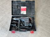 a drill in a case on the floor
