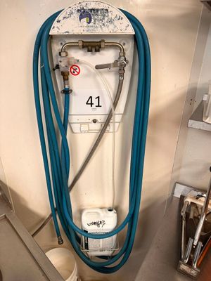 a blue hose attached to a water heater in a room