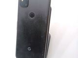 the back of a black google pixel phone sitting on top of a white surface