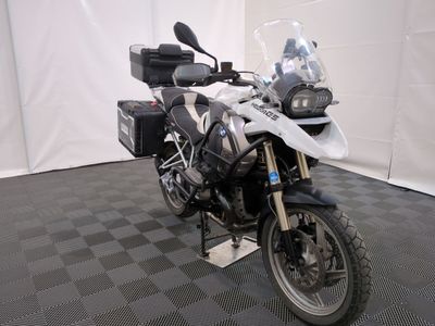 a motorcycle that is parked on a black and white checkered floor