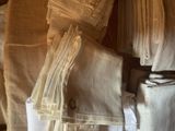 a lot of folded towels on a chair in a room