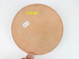 a hand that is holding a plate with a sticker on it