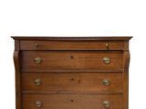 a wooden chest of drawers with brass pulls and drawers