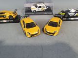 three toy cars sitting next to each other on a table