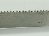 a close up of a saw blade on a white surface