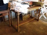 a wooden table with a bunch of clothes on top of it