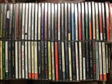 a lot of cds stacked on top of each other