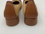 a close up of a pair of brown shoes on a white surface