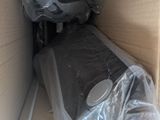 a cardboard box with a mattress and a plastic bag in it