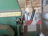 a machine that is working on a piece of wood