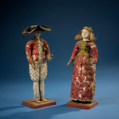 deux figurines représentant un homme et une femme vêtus de costumes d'époque