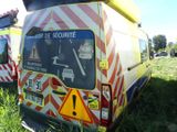 two ambulances that are parked in the grass